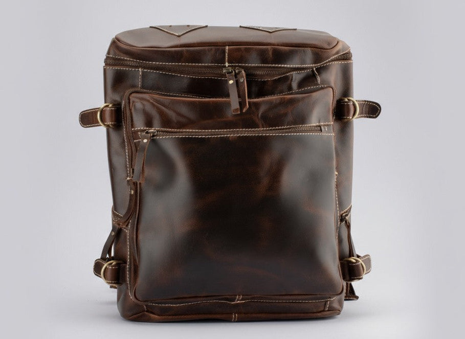 Brown leather backpack on a light gray background