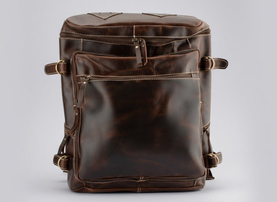 Brown leather backpack on a light gray background